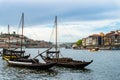 Typical portuguese boats transporting wine barrels on the river Douro in Porto Royalty Free Stock Photo