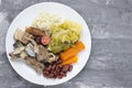 Typical portuguese dish boiled meat, smoked sausages, vegetables and rice on white plate Royalty Free Stock Photo