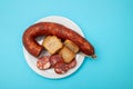 typical portuguese smoked sausage chourico on white plate Royalty Free Stock Photo