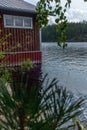 A typical red boat house on the shore of the Saimaa lake in Fin