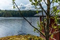 A typical red boat house on the shore of the Saimaa lake in Fin