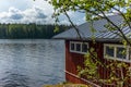 A typical red boat house on the shore of the Saimaa lake in Fin Royalty Free Stock Photo