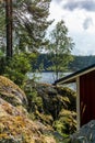 A typical red boat house on the shore of the Saimaa lake in Fin