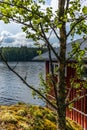 A typical red boat house on the shore of the Saimaa lake in Fin