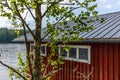 A typical red boat house on the shore of the Saimaa lake in Fin