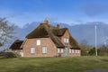 Typical red brick Frisian house with thatched roof on Sylt island in List village, Germany Royalty Free Stock Photo