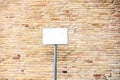 typical red brick wall background with blank white plaque Royalty Free Stock Photo