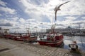 Typical red fishing boats docked in the dock of the port with a seagull flying Royalty Free Stock Photo