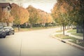 Typical residential neighborhood with American flag in fall seas