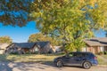 Typical residential street with parked car in front of residential house and colorful autumn leaves in Texas, USA Royalty Free Stock Photo