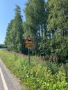 A typical road signal for danger of crossing moose in Finland