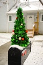 A mailbox decorated for the Christmas Holidays with a small Christmas tree. Royalty Free Stock Photo