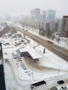 Typical Russian city, gas station and buildings during winter time.