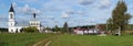 Typical rustic Russian landscape - a church next to fields, road