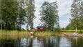 A typical scandinavian red wooden cottage on the shores of lake Saimaa in Finland Royalty Free Stock Photo