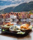 Typical Scandinavian sandwiches against Bryggen street with boats in Bergen, UNESCO World Heritage Site, Norway