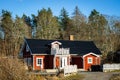 Typical Scandinavian Swedish red wooden house. Road. Countryside authentic cozy old house in rural area Royalty Free Stock Photo