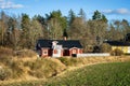 Typical Scandinavian Swedish red wooden house. Road. Countryside authentic cozy old house in rural area Royalty Free Stock Photo