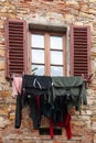 Clothes hung to dry out the window in San Donato, Italy Royalty Free Stock Photo