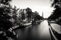 Amsterdam, Holland, the Netherlands - July 6 2020: Long time exposure of the view along a canal with houseboats towards the famous