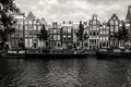 Amsterdam, Holland, the Netherlands - July 6 2020: about 10 lined up canal houses with houseboats in the front in black and white