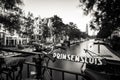 Amsterdam, Holland, the Netherlands - July 6 2020: Long time exposure of the view along a canal with houseboats towards the famous