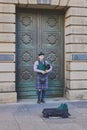 Typical Scottish bagpipe player on the streets of Edinburgh Royalty Free Stock Photo