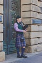 Typical Scottish bagpipe player on the streets of Edinburgh Royalty Free Stock Photo