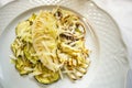 Typical Sicilian cuisine, roasted squid, with olive oil and oregano on a bed of courgettes.