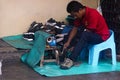 Side-walk Cobbler Plying His Trade In Malaysia