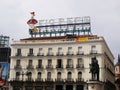 Typical sign of Tio Pepe on the roof of a building and the monument to King Carlos III in Puerta del Sol square. Madrid Royalty Free Stock Photo