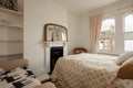 Typical small bedroom within British Victorian home including fireplace Royalty Free Stock Photo