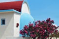 Typical small Greek house with oleander bushes