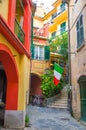 Typical small italian yard with buildings houses, stairs, shutter window and italian flag in Monterosso village, National park Cin Royalty Free Stock Photo