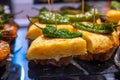 Typical snack in bars of Basque Country, pinchos or pinxtos, small slices of bread withn different toppings and fastened with