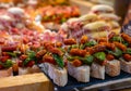 Typical snack of Basque Country and Navarre, pinchos or pinxtos, small piece of bread with different toppings, served in bar,