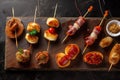 Typical snack of Basque Country, pinchos or pinxtos skewers with small pieces of bread, sea food, eggs, cheese, jamon served in Royalty Free Stock Photo