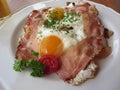 Typical South Tyrolean dish with speck, fried eggs, potatoes and chive . View from above