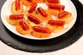 Typical spanish chorizo tapas. Pork sausage called chistorra on bread. Royalty Free Stock Photo
