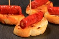 Typical spanish chorizo tapas. Pork sausage called chistorra on bread. Royalty Free Stock Photo