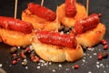 Typical spanish chorizo tapas. Pork sausage called chistorra on bread. Royalty Free Stock Photo