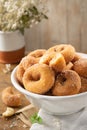 Typical spanish donuts, fried rosquillas with sugar for breakfast on rustic wooden table, traditional homemade anise donuts from