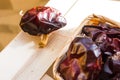 Typical Spanish nyora peppers dried in the sun, on thread in wicker basket on wood box, outdoors