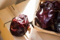 Typical Spanish nyora peppers dried in the sun, on thread in wicker basket on wood box