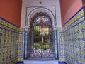 typical spanish patio with wrought iron gate, tiles and flowers