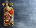 Typical spanish tapas concept. include variety slices jamon, chorizo, salami, bowls with olives, peppers, anchovies Royalty Free Stock Photo