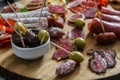 Typical spanish tapas concept. include variety slices jamon, chorizo, salami, bowls with olives, peppers. Copyspace. Royalty Free Stock Photo