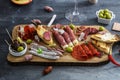 Typical spanish tapas concept. include variety slices jamon, chorizo, salami, bowls with olives, peppers. Copyspace. Royalty Free Stock Photo