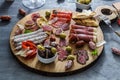 Typical spanish tapas concept. include variety slices jamon, chorizo, salami, bowls with olives, peppers. Copyspace. Royalty Free Stock Photo