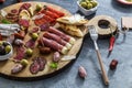 Typical spanish tapas concept. include variety slices jamon, chorizo, salami, bowls with olives, peppers. Copyspace. Royalty Free Stock Photo